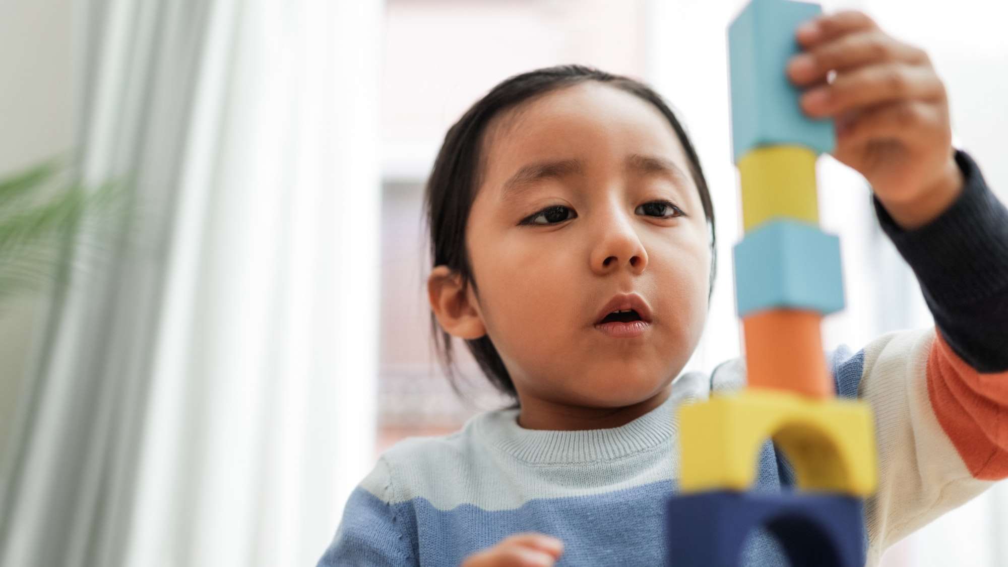Young asian kid playing with color blocks at home - Kindergarten educational games